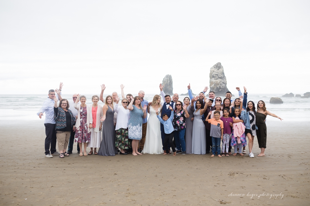 wedding couple in front of haystack rock at their cannon beach wedding