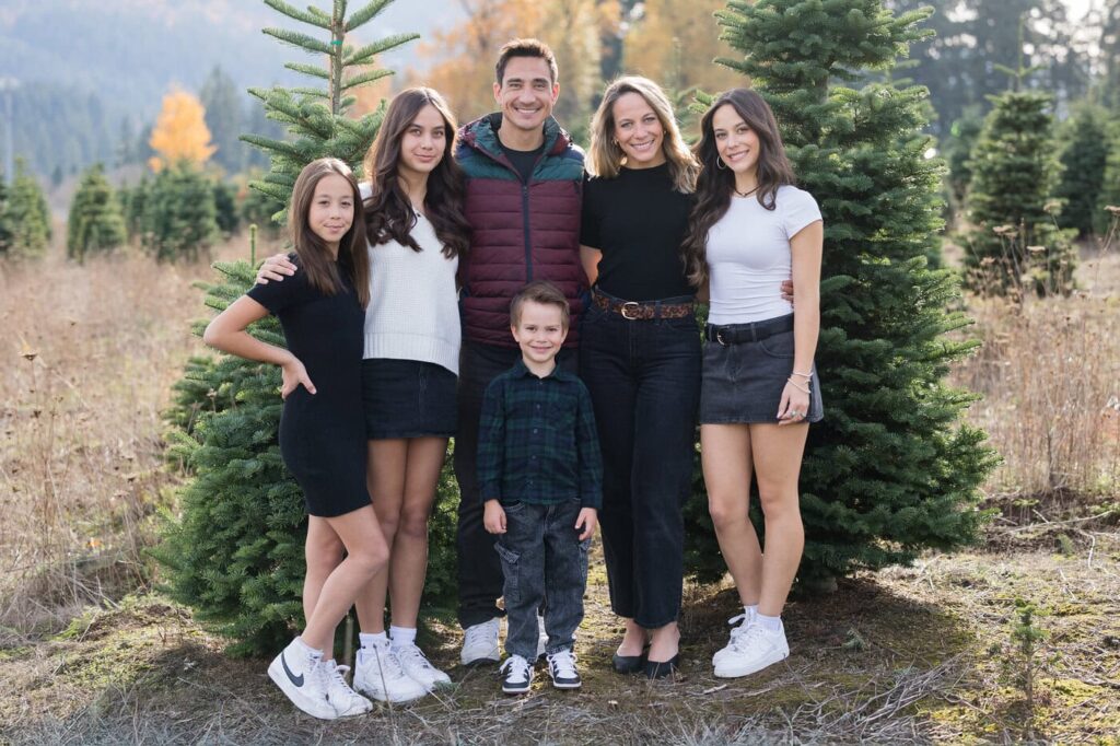 family photos by christmas trees